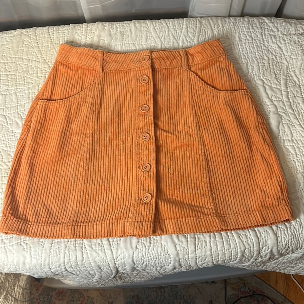 Forever 21, light orange, corduroy, button up skirt. Size Medium.
